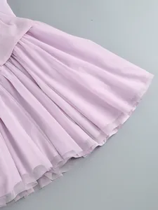 Close-up detail of lavender purple pleated mesh tulle dress showing fabric texture