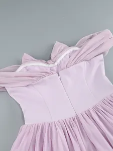 Detailed view of the back zipper and pleated mesh on a lavender off-shoulder gown.
