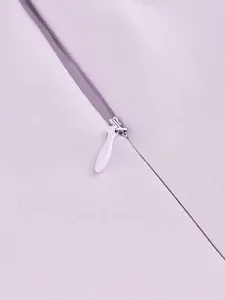 Close-up detail of lavender purple dress showing invisible zipper and fabric texture