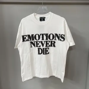 Oversized white T-shirt featuring black rhinestone Emotions Never Die typography design