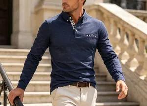 Detailed shot of navy long-sleeved polo shirt with plaid collar and pocket trim