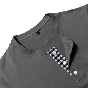 Close-up detail of men's long sleeve grey Henley shirt showing checked placket and buttons