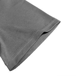 Macro view of moisture-wicking fabric and double-stitched hem on grey polo shirt sleeve