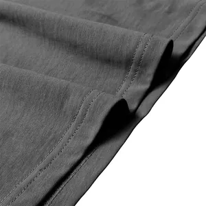 Macro detail of charcoal gray Henley shirt showing neat double-row hem stitching