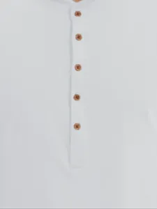 Close-up detail of a white pure cotton Henley shirt featuring decorative brown buttons