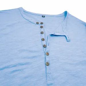 Close-up detail of a light blue men's Henley shirt showing slub cotton texture and buttons