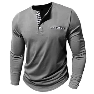 Detail of a men's grey long sleeve Henley shirt with plaid patchwork pocket and placket.