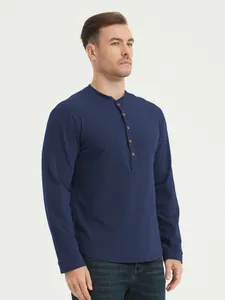 Close-up detail of a dark blue cotton long-sleeved Henley shirt with button placket