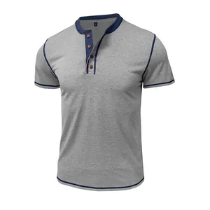 Close-up of men's gray short sleeve Henley T-shirt with navy blue trim and four buttons.