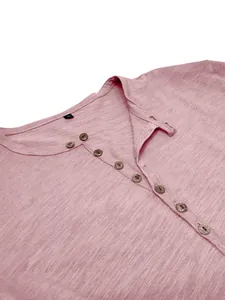 Close-up detail of a pink men's Henley shirt showing slub cotton fabric and buttons