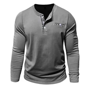 Detailed view of gray Henley shirt with black and white checkered trim on collar and pocket