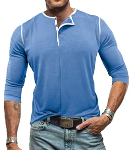 Close-up detail of blue men's long sleeve Henley shirt with white contrast trim and buttons