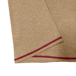 Close-up of red double stitching detail on breathable khaki men's T-shirt fabric