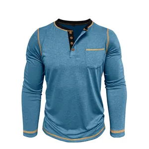 Detailed view of a blue men's long sleeve Henley t-shirt with contrast stitching and pocket.