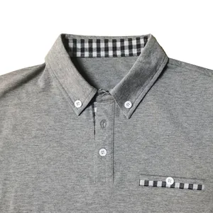 Close-up of a grey men's polo shirt featuring plaid collar and pocket details