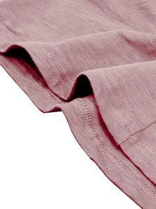 Close-up of slub cotton fabric texture and stitching on men's dusty rose Henley shirt.