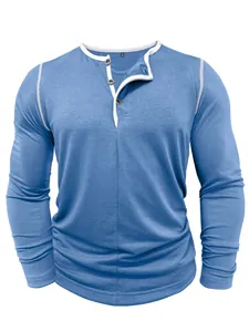 Close-up view of a light blue men's long sleeve Henley shirt featuring a white button placket