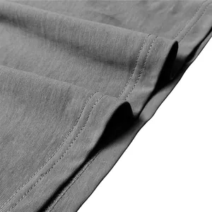 Macro close-up detail of grey men's long sleeve T-shirt showing quality double stitching