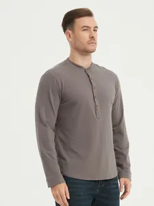 Detail view of a classic men's grey long sleeve cotton Henley shirt with wooden buttons