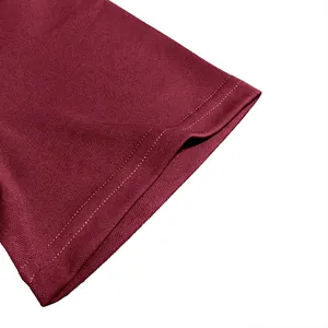 Macro view of stitching and pique knit fabric on a maroon men's polo shirt