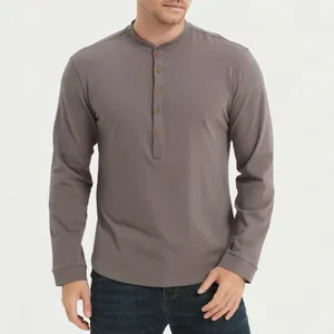 Detail view of a gray long-sleeved Henley shirt showing buttoned placket and fabric texture.