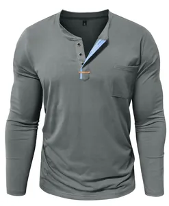 Detail of men's grey Henley shirt with blue placket accent and pocket