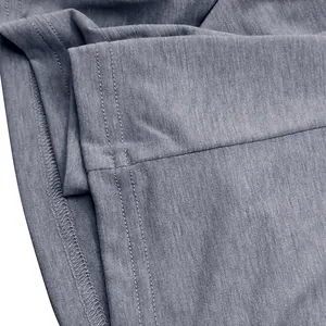 Detailed macro view showing professional double stitching on breathable grey cotton T-shirt fabric
