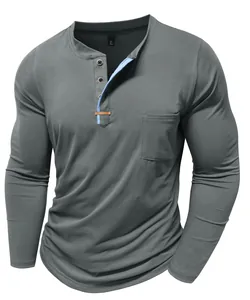 Detailed view of gray long-sleeved Henley shirt with blue contrast placket and pocket