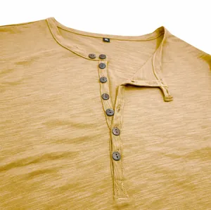 Detailed view of the slub cotton fabric and buttoned collar of a men's Henley shirt.