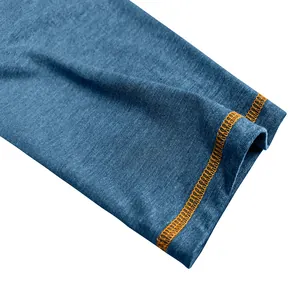 Detailed macro view of the blue sleeve cuff featuring vibrant orange contrast stitching