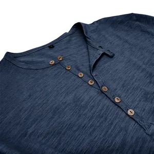 Close-up of blue slub cotton Henley shirt with brown buttons and textured fabric