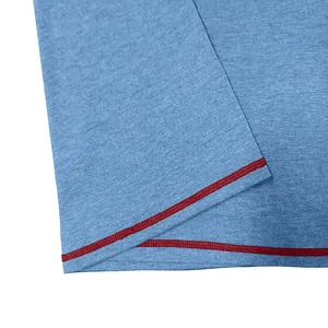 Close-up of men's blue breathable T-shirt featuring contrast red flatlock stitching details.