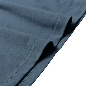 Close-up detail of high-quality double-needle stitching on blue cotton long-sleeve T-shirt