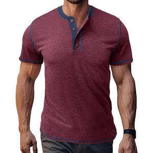 Detailed shot of a men's burgundy Henley T-shirt with navy blue contrast trim
