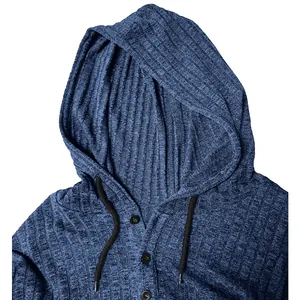 Close-up of blue ribbed knit men's hoodie with black drawstrings and button detail.