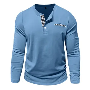 Close-up detail of a men's light blue long-sleeve Henley shirt featuring checkered accents