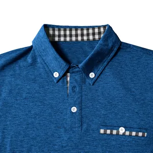 Macro shot of a men's blue polo shirt featuring checkered patchwork collar and pocket detail
