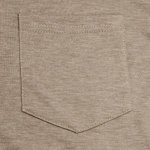 Detailed close-up showing the breast pocket and breathable cotton knit fabric texture.