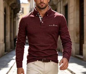 Detailed view of men's burgundy long-sleeve polo shirt with plaid collar accent