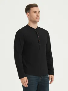 Close-up of a men's black long-sleeve Henley shirt with button details