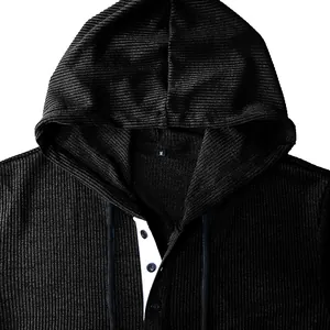 Detail view of black corduroy men's Henley hoodie showing button placket and fabric texture