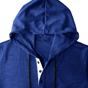 Detail view of men's blue corduroy hooded Henley shirt with buttons and drawstrings