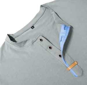Detailed view of gray men's Henley shirt neckline featuring a blue contrast inner placket