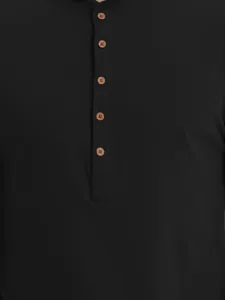 Close-up of black cotton Henley shirt with brown wood-effect buttons on front placket