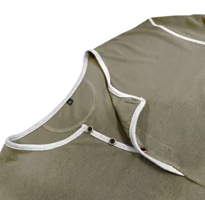 Close-up of olive green Henley shirt collar with buttons and white trim