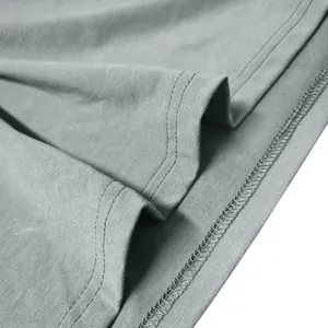 Detailed close-up showing the double-stitched hem and fabric texture of a grey Henley t-shirt