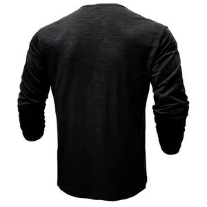 Back view of men's long sleeve black Henley shirt in textured slub cotton fabric