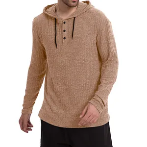Detailed view of camel ribbed knit long sleeve henley hoodie with button collar.