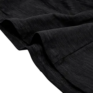 Close-up macro view of black slub cotton fabric texture and stitching detail of Henley shirt