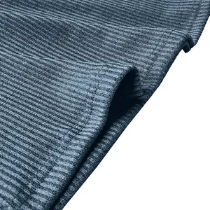 Detailed macro view showing the blue ribbed fabric texture and stitching of a men's shirt